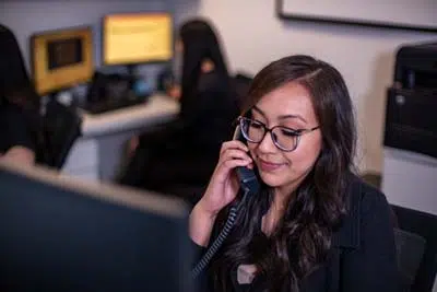 Sycamore Smiles front office coordinator talking on the phone with a patient